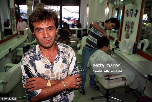 Germany, Dortmund, 1998: Turkish businessmen in Germany.- Hairdresser s shop.