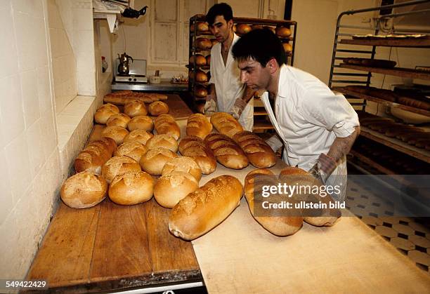 Germany, Dortmund, 1998: Turkish businessmen in Germany.- Employees of a breads factory at work.