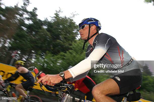 Germany, Frankfurt: Ironman. - Look at three participants while they are riding bikes.