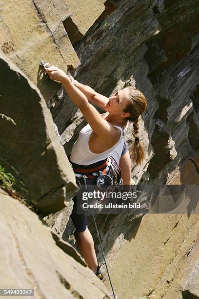 Germany, Hattingen: The climbing crag of the "Deutschen Alpenverein DAV Isenberg". A woman climbs