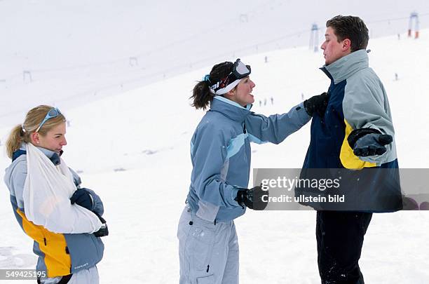 Germany: Free time.- Young persons skiing and snowboarding in the mountains; injury.