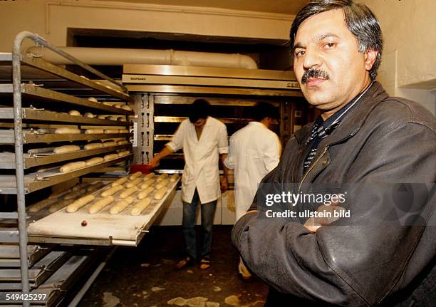 Germany, Dortmund, 1998: Turkish businessmen in Germany.- The manager of a breads factory; employees at work.