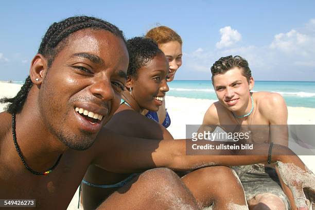 Cuba: Portrait of young people at the beach.