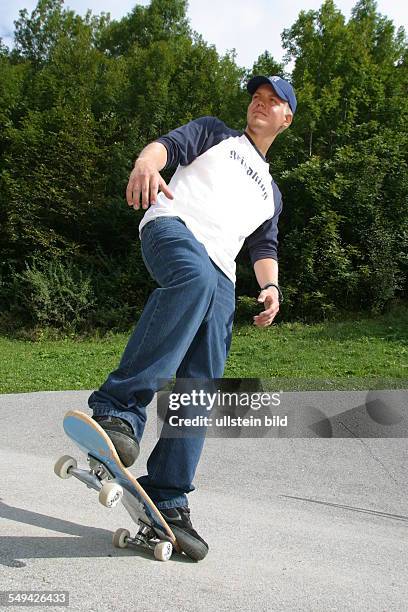 Germany, : A young man skateboarding.