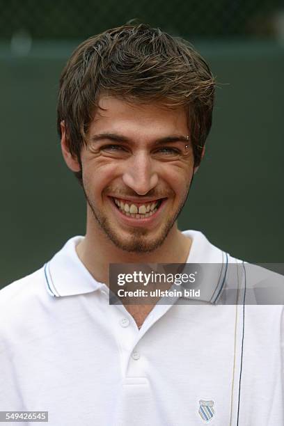 Germany, : Portrait of a young man in tennis kit.