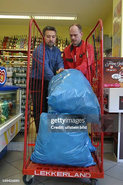 Germany, 2003: Deposit.- Turkish market; the bin liners filled with empty bottles and tins are collected and loaded on a .