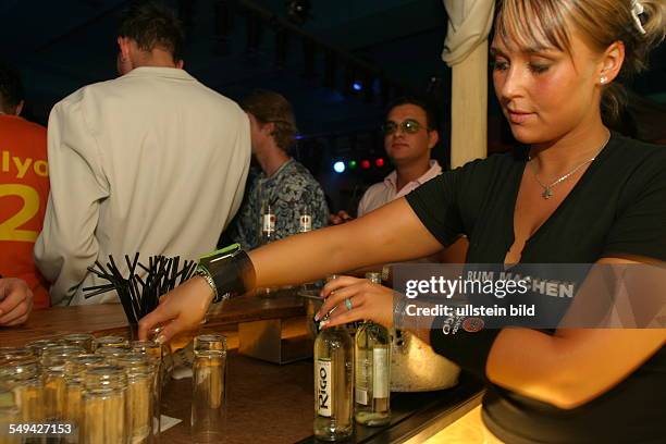 Germany: Young persons at nightlife.- Alcoholic mixed drinks at the bar; Bacardi Rigo.