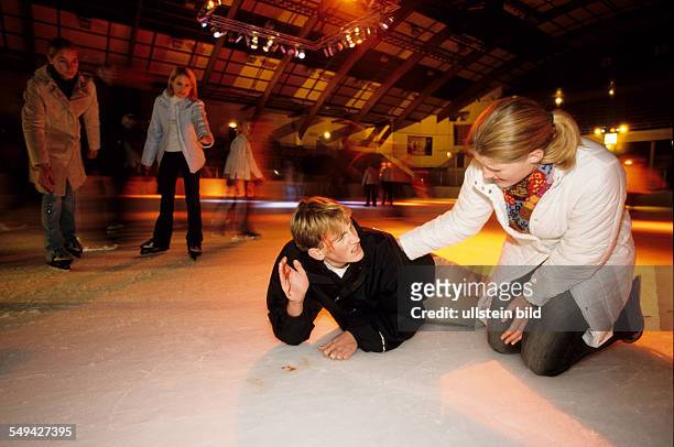 Germany: Free time.- While skating in an ice-skating rink; a boy falled and is lieing on the ice being injured.