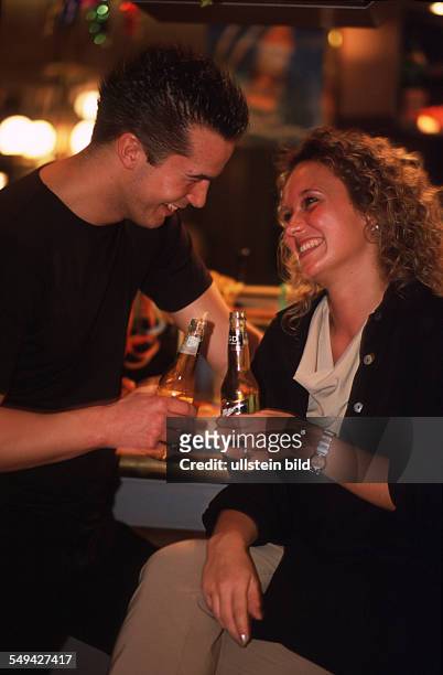 Germany: Bowling.- A couple enjoying their time at the bar.