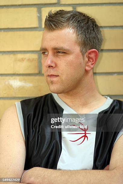 Germany, : Free time.- Portrait; a young man in sporting clothes.