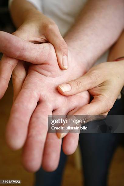 Germany: Therapy. A patient during the therapy for the hands.