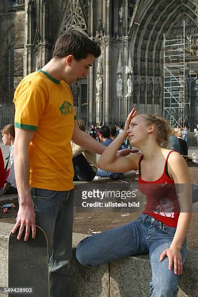 Germany, Cologne: Youth in their free time.- Talk between two friends.