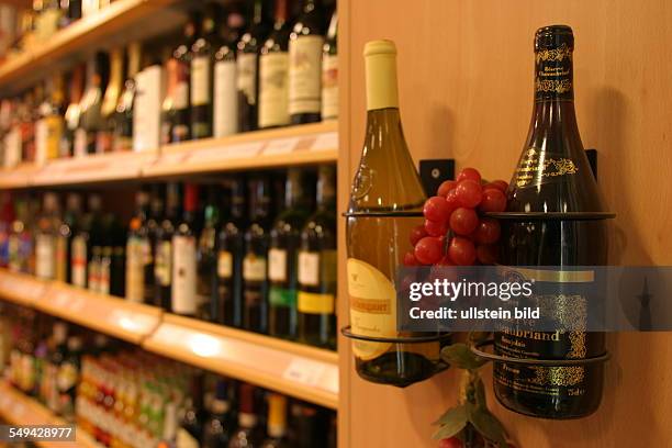 Germany, Kalkar, : Filling station.- Shelves of goods; range of wine.