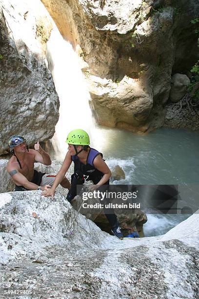 Turkey: A woman and a man during a climbing tour in the mountains; at a mountain lake.