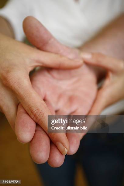 Germany: Therapy. A patient during the therapy for the hands.