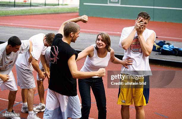 Germany: Free time.- Young men playing basketball; confrontation.