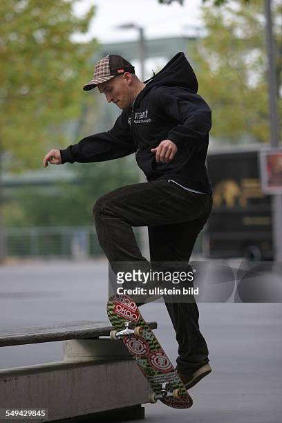 Germany: Young persons in their free time.- A young man is riding a skateboard.