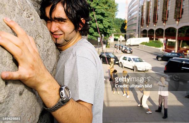 Germany: Free time.- Young man climbing.