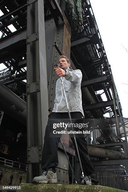 Germany, Duisburg: Nordic Walking.- A young man in the landscape park Duisburg-North. Model Release: Yes