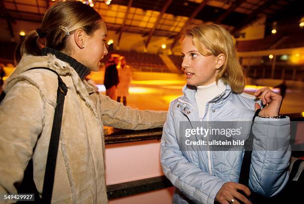 Germany: Free time.- Two young girls in an ice-skating rink.