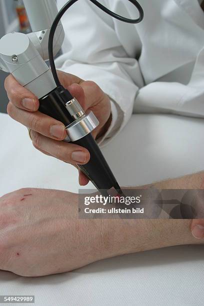 Germany, Essen, medicine physicist and non-medical practitioner Holger May, manager of the Laser Forum Essen. A patient during a laser treatment....