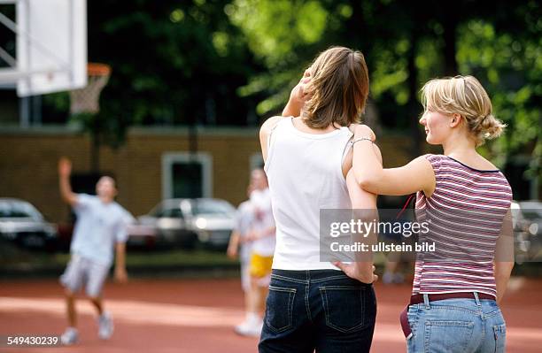 Germany: Free time.- Two women are watching a basketball match.