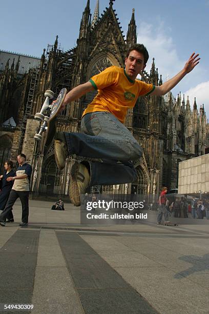 Germany, Cologne: Youth in their free time.- A young man skateboarding.