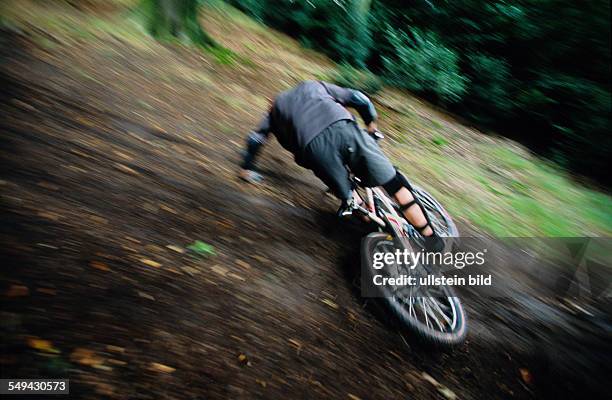 Germany: Free time.- Bicyclists in the wood, he is falling.