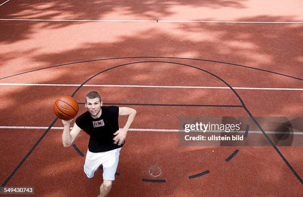 Germany: Free time.- A young man playing basketball.