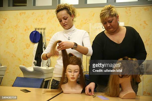 Germany, Duisburg - Marxloh: "Kolpinghaus", Melek Cabri and Serpil Kara, Turks, complete a hairdresse training.