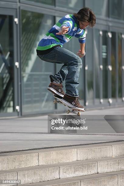 Germany: Young persons in their free time.- A young man is riding a skateboard.