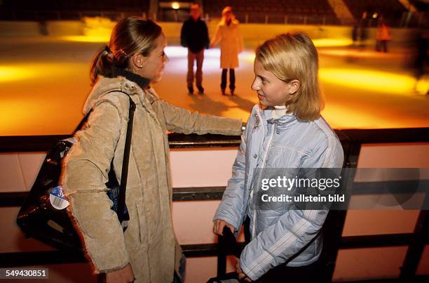 Germany: Free time.- Two young girls in an ice-skating rink.