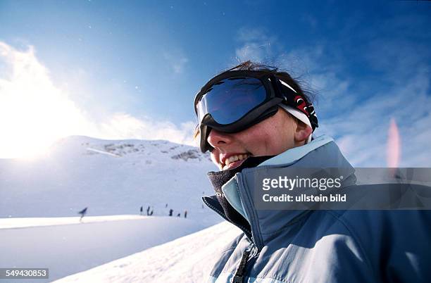Germany: Free time.- Portrait of a young woman in the snow in the mountains.