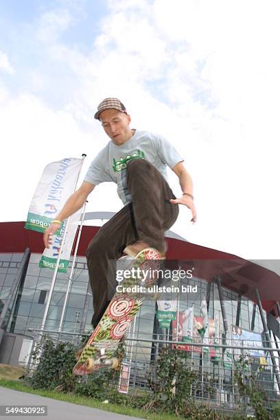 Germany: Young persons in their free time.- A young man is riding a skateboard.