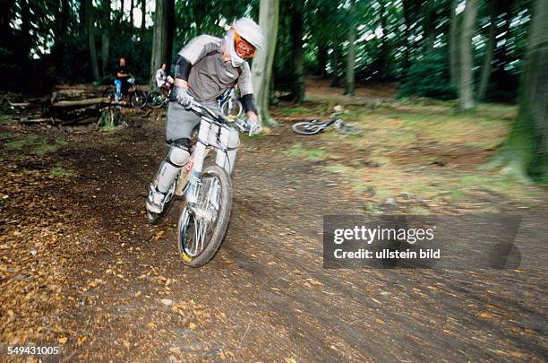 Germany: Free time.- Bicyclists in the wood.