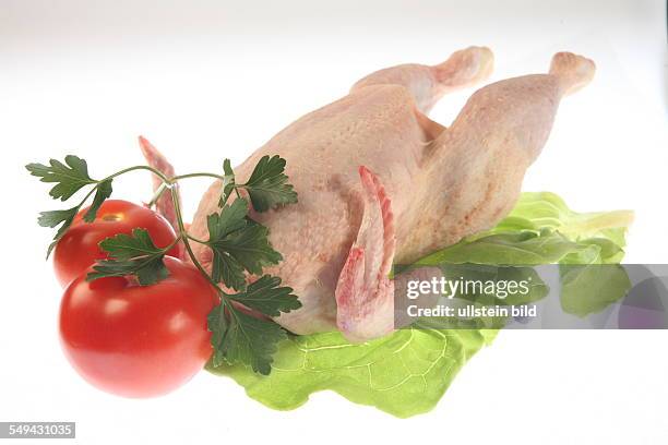 Germany, Food - meat.- A chicken, on lettuce, with tomatoes.