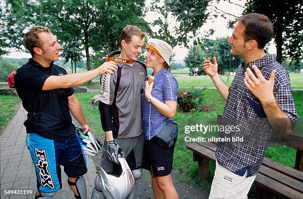 Germany: Free time.- Young persons meeting in a park.