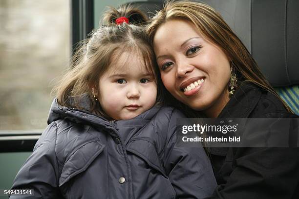 Germany, Dortmund: In a train.- A 4 years old girl with her aunt.