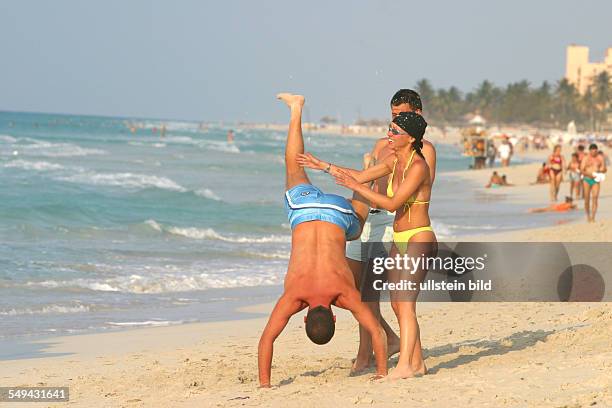 Cuba: Young persons at the beach.
