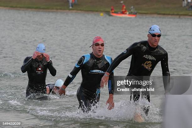 Germany, Frankfurt: Ironman. - Three participants in the water.