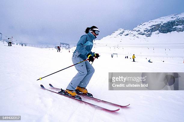 Germany: Free time.- Young person skiing in the mountains.