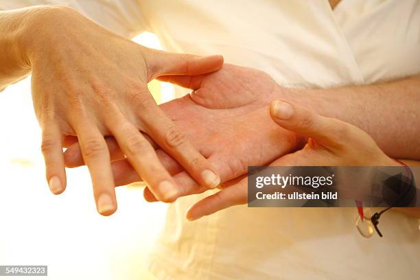 Germany: Therapy. A patient during the therapy for the hands.