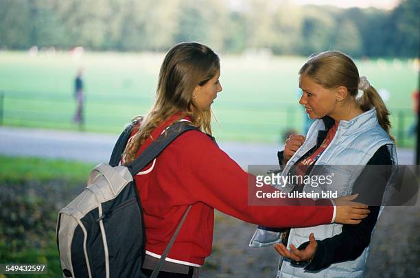 Germany: Free time.- Two young women talking.