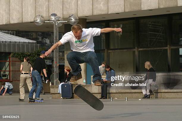 Germany, Cologne: Youth in their free time.- A young man skateboarding.