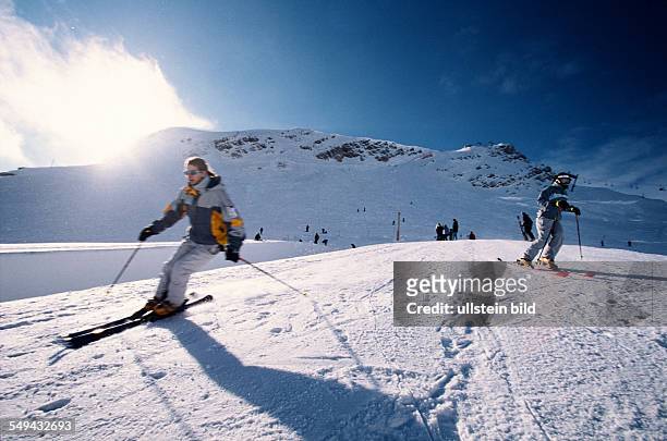Germany: Free time.- Young person skiing in the mountains.