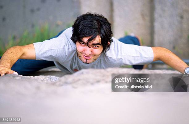 Germany: Free time.- Young man climbing.