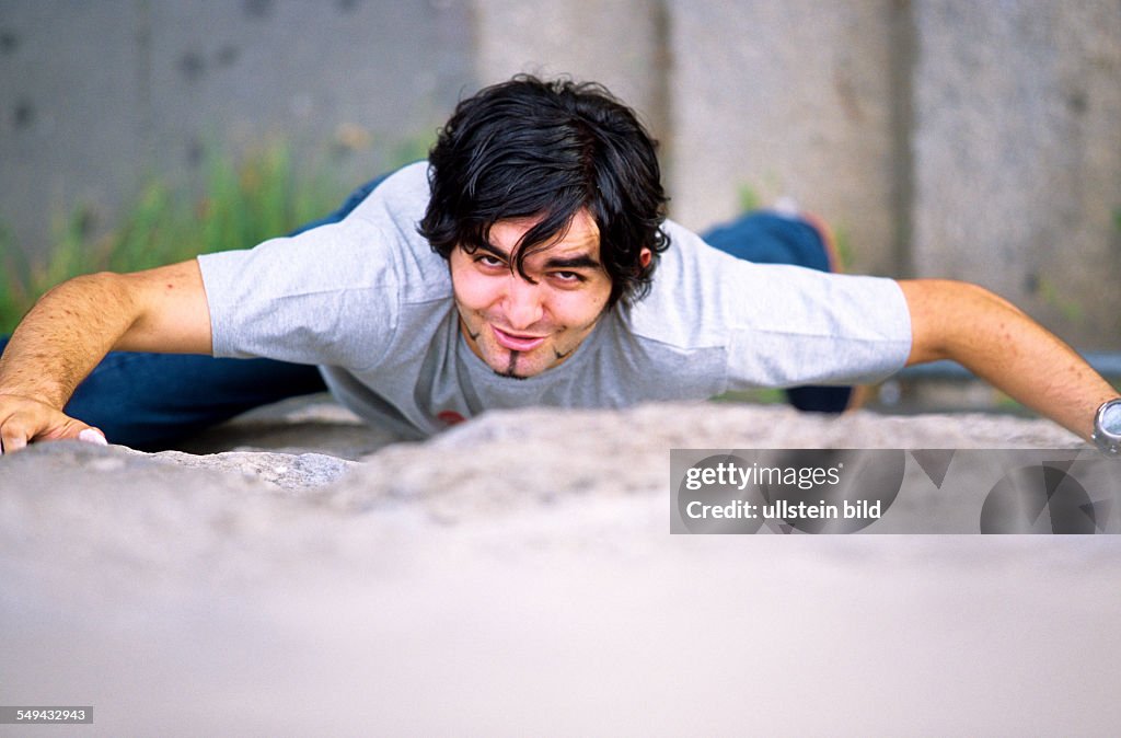 DEU, Germany: Free time.- Young man climbing.