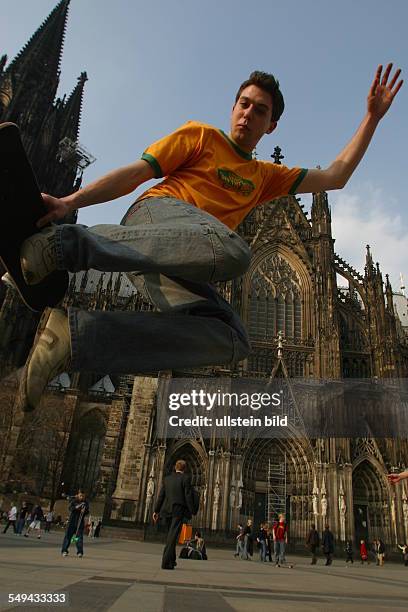 Germany, Cologne: Youth in their free time.- A young man skateboarding.