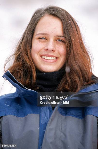 Germany: Free time.- Portrait of a young woman in the snow.