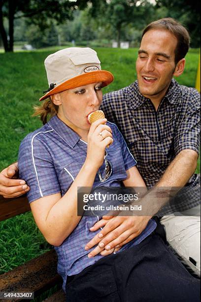 Germany: Free time.- A man giving an ice cream to his girlfriend.